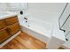 Bathroom featuring a built-in bathtub, wood floors, and modern fixtures at 9741 Horizon Hills Dr, Las Vegas, NV 89117
