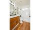 Bathroom featuring a shower-tub combo, wood floors, and a single sink vanity at 9741 Horizon Hills Dr, Las Vegas, NV 89117