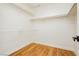 Spacious walk-in closet featuring custom white shelving and wood floors at 9741 Horizon Hills Dr, Las Vegas, NV 89117