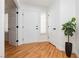 Bright entryway featuring hardwood floors, with coat closet and shiplap at 9741 Horizon Hills Dr, Las Vegas, NV 89117