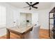 Comfortable home office with modern ceiling fan, shelving unit and stylish desk at 9741 Horizon Hills Dr, Las Vegas, NV 89117