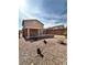 View of backyard with covered patio, rock landscaping, and privacy fence, perfect for relaxing outdoors at 9844 Ashton Pines Ct, Las Vegas, NV 89147