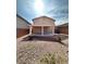 Inviting backyard with covered patio, low maintenance landscaping, and block fencing at 9844 Ashton Pines Ct, Las Vegas, NV 89147