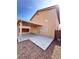 Backyard view of home featuring covered patio, slider door, and low-maintenance desert landscaping at 9844 Ashton Pines Ct, Las Vegas, NV 89147
