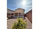 Image showcasing a backyard with a covered patio, rock landscaping, and a secure fence at 9844 Ashton Pines Ct, Las Vegas, NV 89147