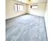 Spacious carpeted bedroom with natural light from two windows, perfect for relaxation at 9844 Ashton Pines Ct, Las Vegas, NV 89147