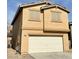 Two-story home featuring a two-car garage and neutral stucco exterior with a gas meter at 9844 Ashton Pines Ct, Las Vegas, NV 89147