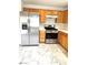 Kitchen featuring stainless steel appliances, wood cabinets, and marble floors at 9844 Ashton Pines Ct, Las Vegas, NV 89147