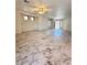 Spacious living room featuring tile floors, ample sunlight, and an open layout at 9844 Ashton Pines Ct, Las Vegas, NV 89147