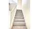 Carpeted staircase with white railing leads to the upper level of the home at 9844 Ashton Pines Ct, Las Vegas, NV 89147