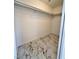 Walk-in closet features modern marble floors and ample storage at 9844 Ashton Pines Ct, Las Vegas, NV 89147