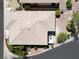 Aerial view of a well-maintained roof, lush landscaping, and mature trees at 10532 Redwood Ash Ave, Las Vegas, NV 89144