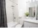 Bright bathroom featuring a tub with shower, toilet, and vanity with marble countertop at 10532 Redwood Ash Ave, Las Vegas, NV 89144