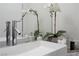 Close-up of a modern bathroom sink with sleek faucet, elegant orchid, and vanity accessories at 10532 Redwood Ash Ave, Las Vegas, NV 89144