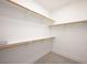 A simple, clean walk-in closet with wooden racks at 10532 Redwood Ash Ave, Las Vegas, NV 89144