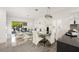 Open-concept dining area and living room with sleek tile floors and access to outdoor patio at 10532 Redwood Ash Ave, Las Vegas, NV 89144