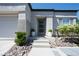 Inviting front entrance with landscaped walkway and stylish front door with glass panels at 10532 Redwood Ash Ave, Las Vegas, NV 89144