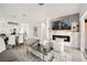 Elegant living and dining area with modern lighting, fireplace, and open layout at 10532 Redwood Ash Ave, Las Vegas, NV 89144