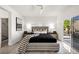 A spacious main bedroom has natural light, modern furnishings, and an ensuite bathroom at 10532 Redwood Ash Ave, Las Vegas, NV 89144