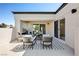 Open-air patio featuring comfortable seating and sliding door entries into the house at 10532 Redwood Ash Ave, Las Vegas, NV 89144