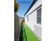 Artificial grass creates a clean and green side yard alongside a well-maintained home exterior at 10532 Redwood Ash Ave, Las Vegas, NV 89144