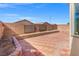 A brick-paved backyard bordered with a low brick wall, providing a cozy and private outdoor space at 10642 Dawns Mist Ave, Las Vegas, NV 89129