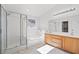 Bathroom featuring a glass-enclosed shower, soaking tub, and double vanity at 10642 Dawns Mist Ave, Las Vegas, NV 89129