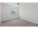 Carpeted bedroom featuring a ceiling fan and one window with a view at 10642 Dawns Mist Ave, Las Vegas, NV 89129