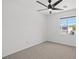 Carpeted bedroom with a ceiling fan, one window, and white walls at 10642 Dawns Mist Ave, Las Vegas, NV 89129