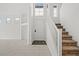 Bright and spacious entryway with staircase featuring carpeted stairs and tile flooring at 10642 Dawns Mist Ave, Las Vegas, NV 89129