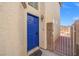 A vibrant blue front door adds a pop of color to this home's exterior, inviting you inside at 10642 Dawns Mist Ave, Las Vegas, NV 89129
