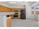 Well-lit kitchen with oak cabinets, stainless steel appliances, and a window view at 10642 Dawns Mist Ave, Las Vegas, NV 89129