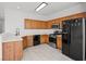 Bright kitchen featuring oak cabinets, stainless steel appliances, and sleek countertops at 10642 Dawns Mist Ave, Las Vegas, NV 89129