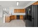 Well-equipped kitchen with oak cabinets, stainless steel appliances, and white countertops at 10642 Dawns Mist Ave, Las Vegas, NV 89129
