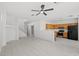 Bright open living space flows into the kitchen area with tile flooring and neutral decor at 10642 Dawns Mist Ave, Las Vegas, NV 89129