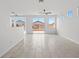 Bright living room featuring tile flooring, a ceiling fan, and sliding glass doors to the backyard at 10642 Dawns Mist Ave, Las Vegas, NV 89129