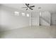 Bright living room with tile flooring, ceiling fan, and a view of the staircase at 10642 Dawns Mist Ave, Las Vegas, NV 89129