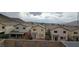 Rear view of the houses featuring a serene backyard space, community living with mountain views on the horizon at 10642 Dawns Mist Ave, Las Vegas, NV 89129