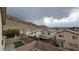 Rear view of several houses showcases the neighborhood with a mountain backdrop, a great community view at 10642 Dawns Mist Ave, Las Vegas, NV 89129