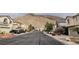 Charming street view showcasing well-maintained homes and the scenic mountain backdrop in the neighborhood at 10642 Dawns Mist Ave, Las Vegas, NV 89129
