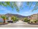 Charming street view showcasing well-maintained homes and lush landscaping, set against a mountain backdrop at 10642 Dawns Mist Ave, Las Vegas, NV 89129