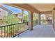 Covered balcony with wrought iron railing overlooking a landscaped backyard at 11816 Orense Dr, Las Vegas, NV 89138