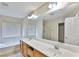 Well-lit bathroom with double sink vanity, soaking tub and glass shower at 11816 Orense Dr, Las Vegas, NV 89138