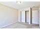 Neutral bedroom features a sliding door closet and a white interior door at 11816 Orense Dr, Las Vegas, NV 89138