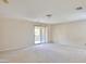 Bright, carpeted bedroom featuring a sliding glass door to a balcony at 11816 Orense Dr, Las Vegas, NV 89138