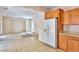 View of the kitchen opening up to the living room, with tile floors and white appliances at 11816 Orense Dr, Las Vegas, NV 89138