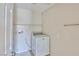 Functional laundry room with a washing machine and overhead shelving at 11816 Orense Dr, Las Vegas, NV 89138
