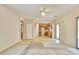 Spacious living room featuring carpeted flooring, neutral paint and access to the kitchen at 11816 Orense Dr, Las Vegas, NV 89138