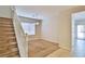 Carpeted living room area featuring staircase and sliding glass doors at 11816 Orense Dr, Las Vegas, NV 89138