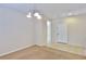 Carpeted living room area featuring tile flooring near door and chandelier at 11816 Orense Dr, Las Vegas, NV 89138
